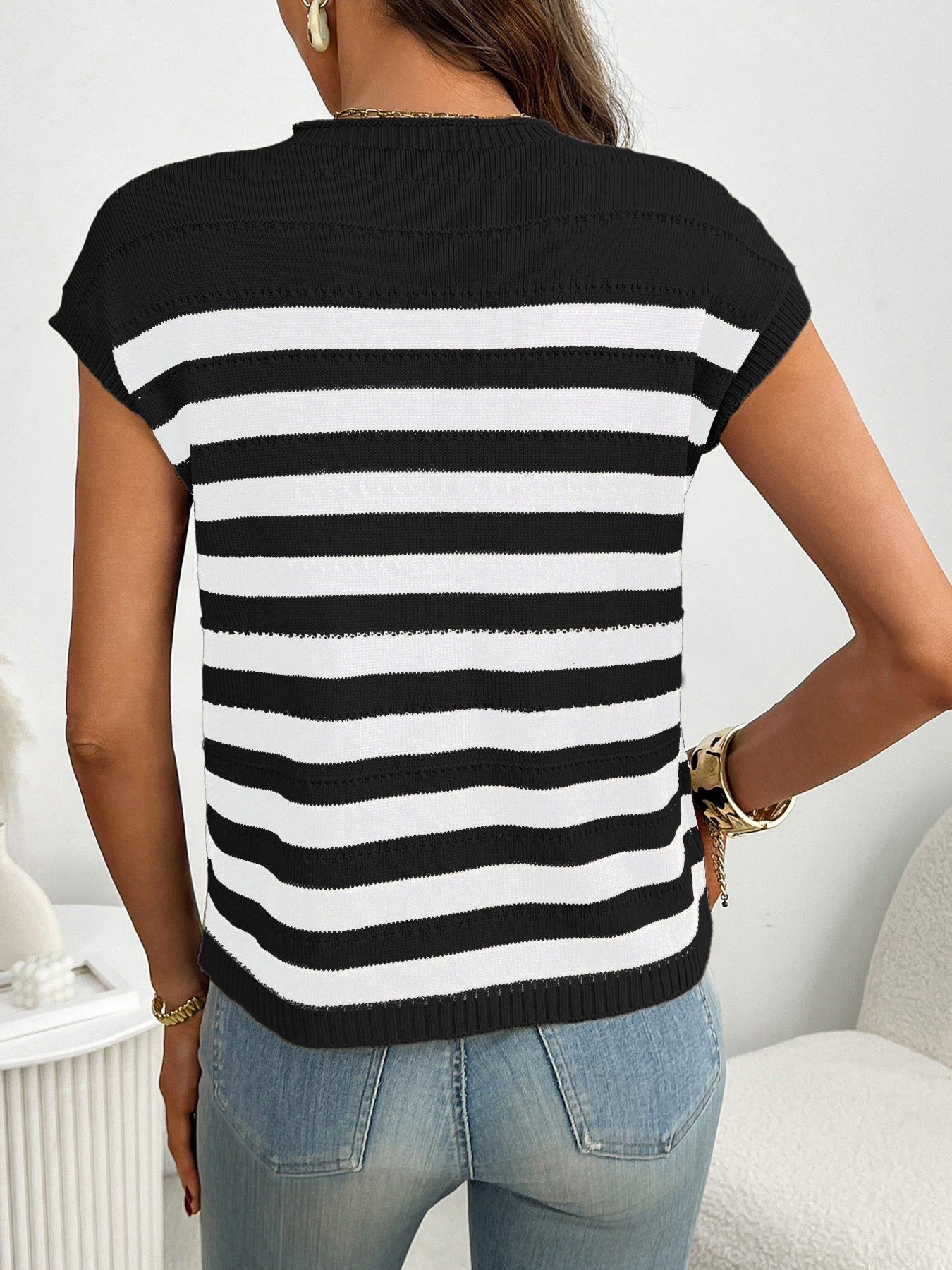 Women's striped knit cap sleeve sweater with pocket detail, featuring a trendy and comfortable design by Trendsi.