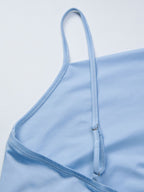 Women's asymmetrical ruched cami top with tie detail, trendy and stylish, featuring a flattering fit and feminine design.
