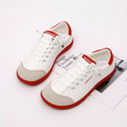 Contrast lace-up casual sneakers made of PU leather and canvas, featuring stylish flat design and trendy fashion details.