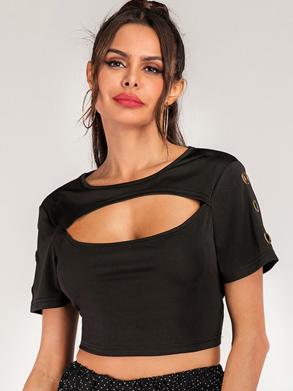 Women's short sleeve cropped tee with grommet cutout details, trendy edgy fashion top by Trendsi.