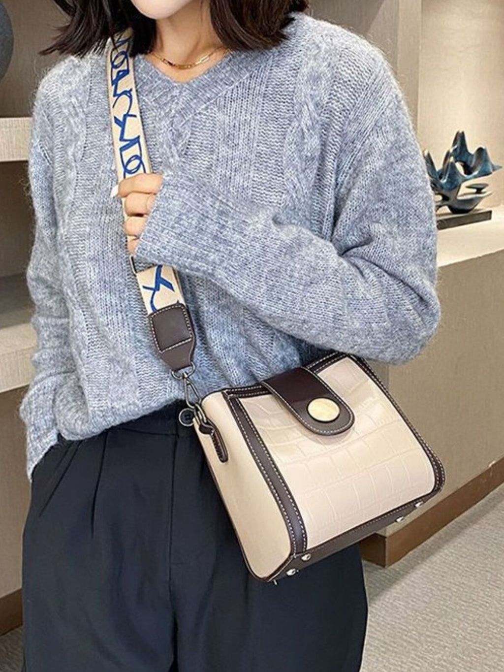 Crocodile embossed wide strap crossbody bag in premium PU leather with sleek design and adjustable strap.