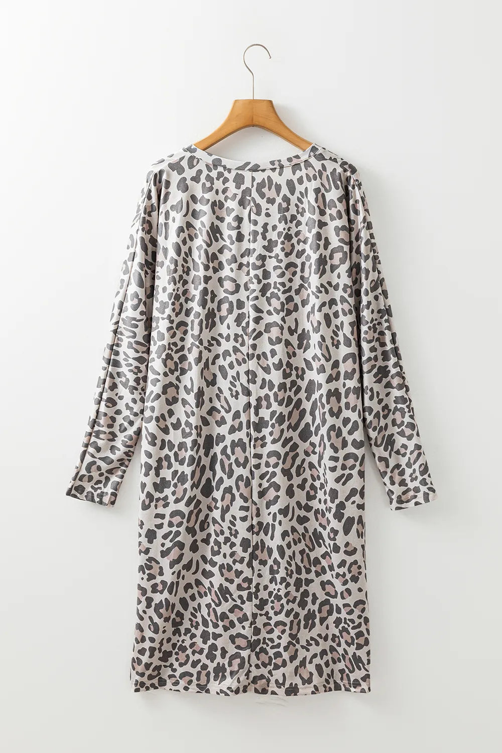 Leopard print V-neck long sleeve dress from Trendsi, stylish and fitted with a flowing skirt, perfect for casual or semi-formal wear.
