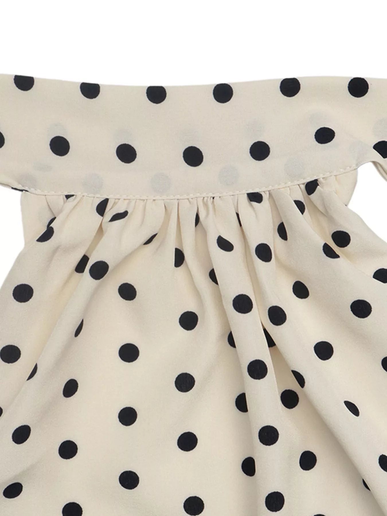 Polka dot halter neck mini dress by Trendsi, featuring a stylish sleeveless design and playful polka dot pattern on lightweight fabric.