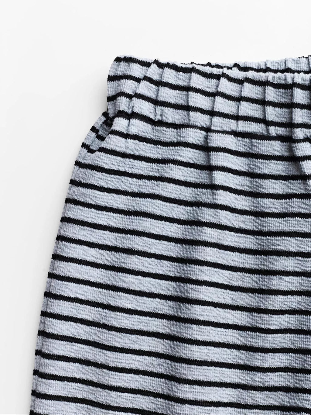 Striped crop top and wide-leg pants set by Trendsi, featuring a stylish matching dress with bold stripe pattern.
