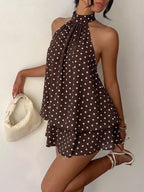 Polka dot halter neck mini dress from Trendsi featuring a fitted bodice and playful pattern, perfect for summer or casual occasions.