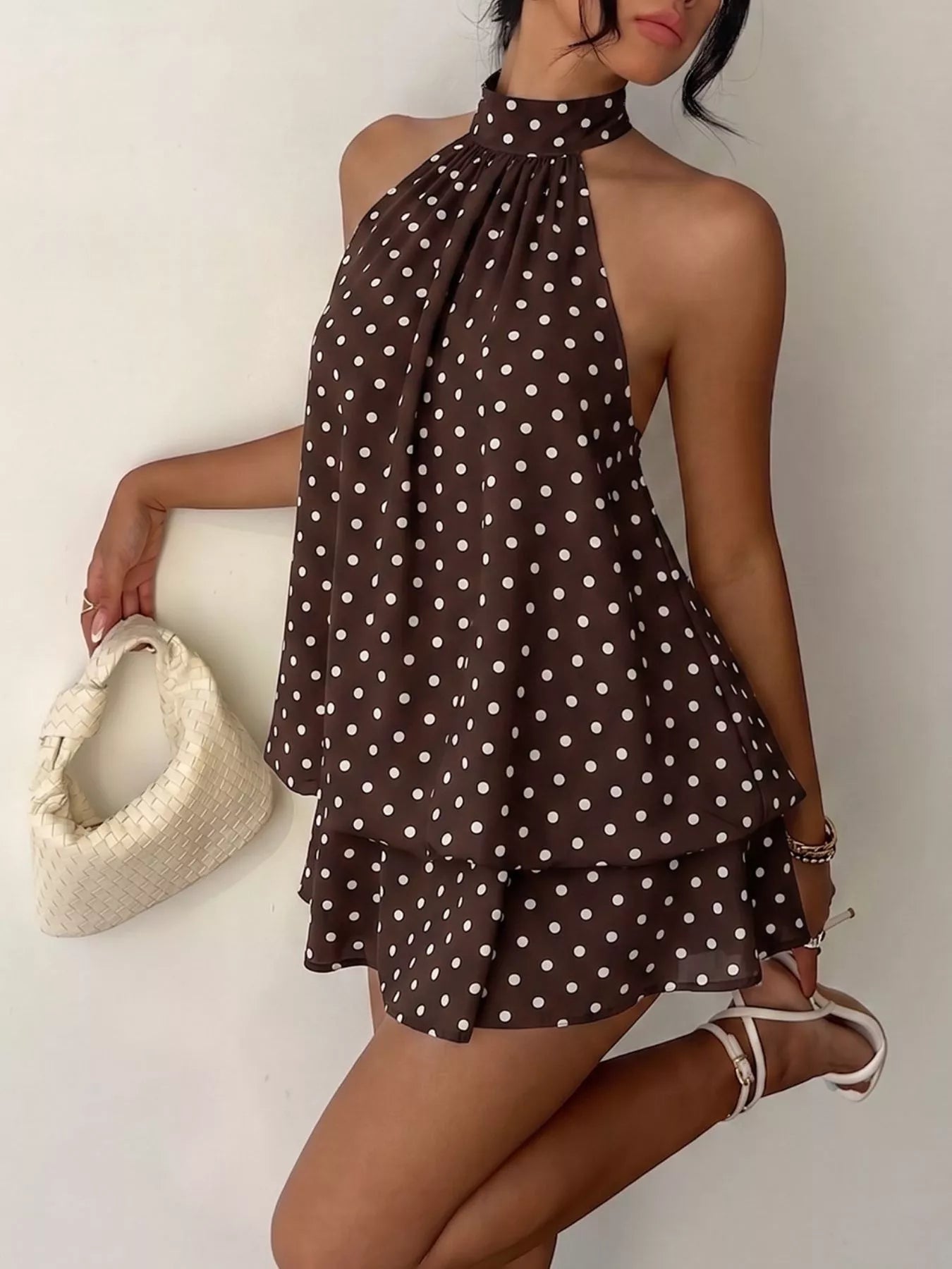 Polka dot halter neck mini dress from Trendsi featuring a fitted bodice and playful pattern, perfect for summer or casual occasions.