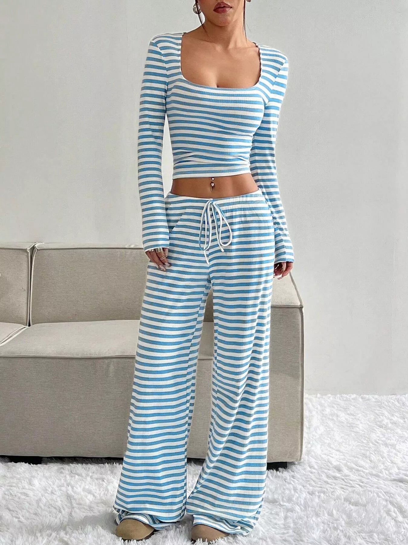 Striped long sleeve crop top and wide-leg pants set by Trendsi, featuring a stylish matching clothing ensemble.