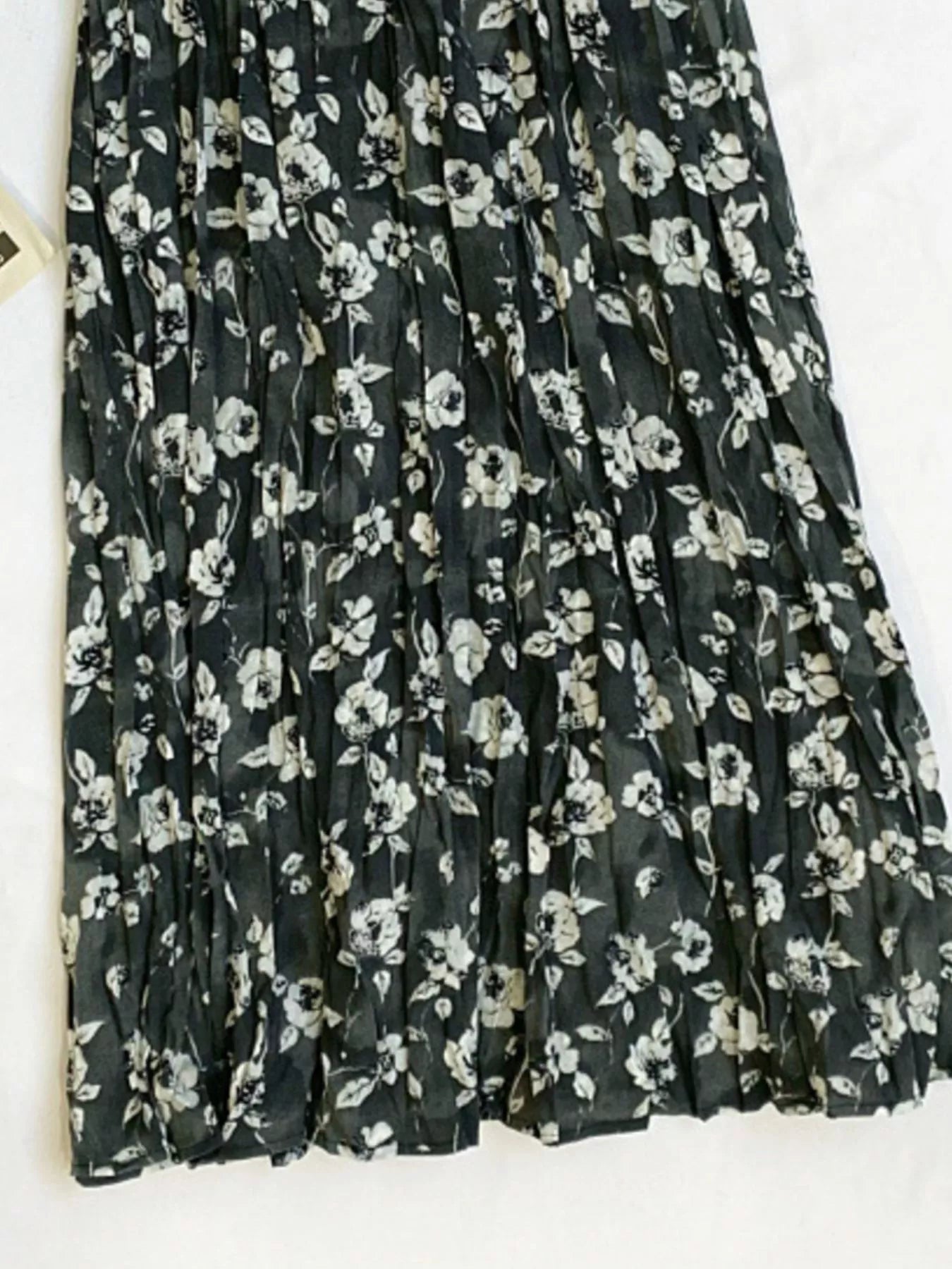Floral print elastic waist midi skirt from Trendsi, featuring a flowy design and vibrant flower patterns, perfect for spring and summer.