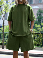 Men's relaxed fit T-shirt and shorts set in plus size, casual trendy outfit by Trendsi, shown in a comfortable relaxed style.