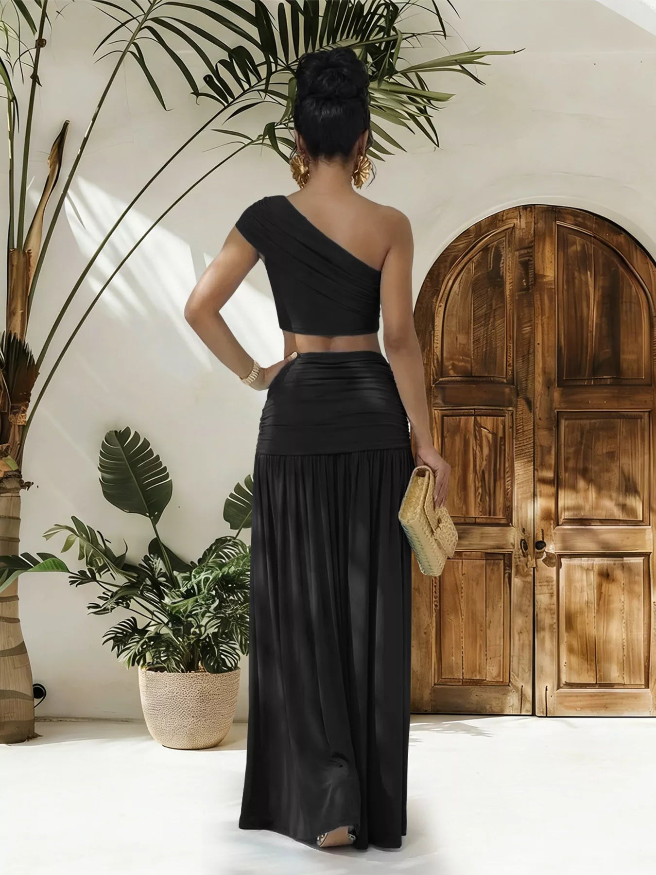 Trendsi one-shoulder top and ruched maxi skirt set displayed on a mannequin, featuring stylish beige fabric with draped details.