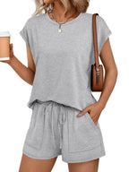 Women's soft round neck cap sleeve lounge set with drawstring shorts, stylish 2-piece set by Trendsi, shown in a cozy fabric.