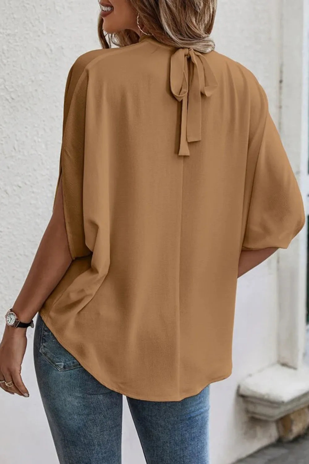 Elegant tie-back half-sleeve blouse with side slit, stylish trendy top from Trendsi, featuring a flowy fit and chic design.
