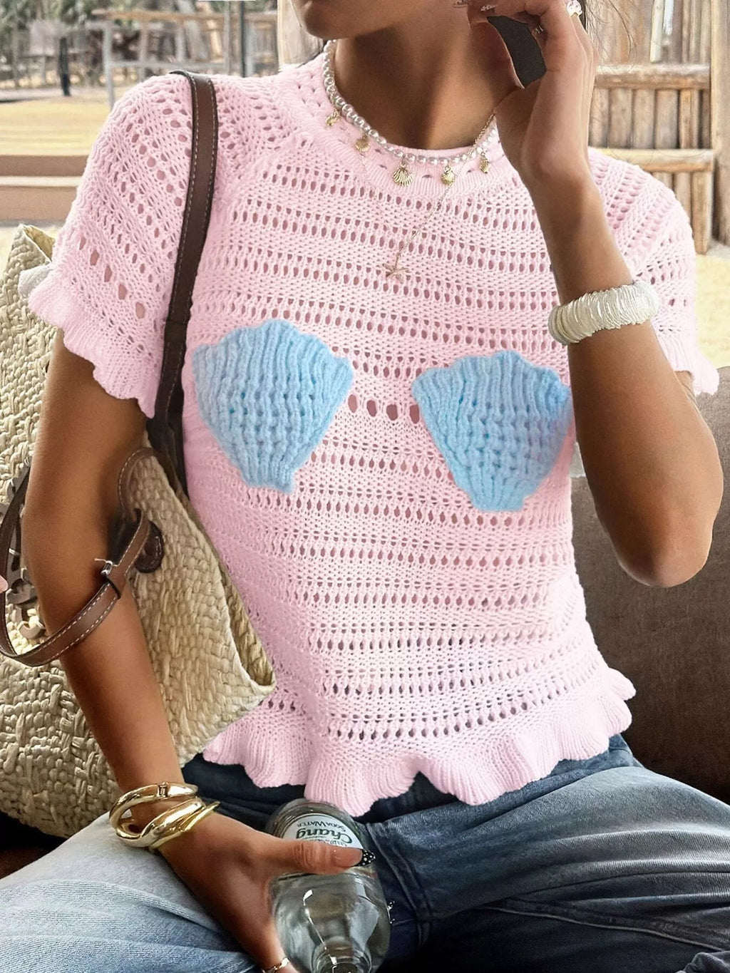 Openwork ruffled hem knit top from Trendsi featuring a stylish open-knit design and feminine ruffled hem detail.