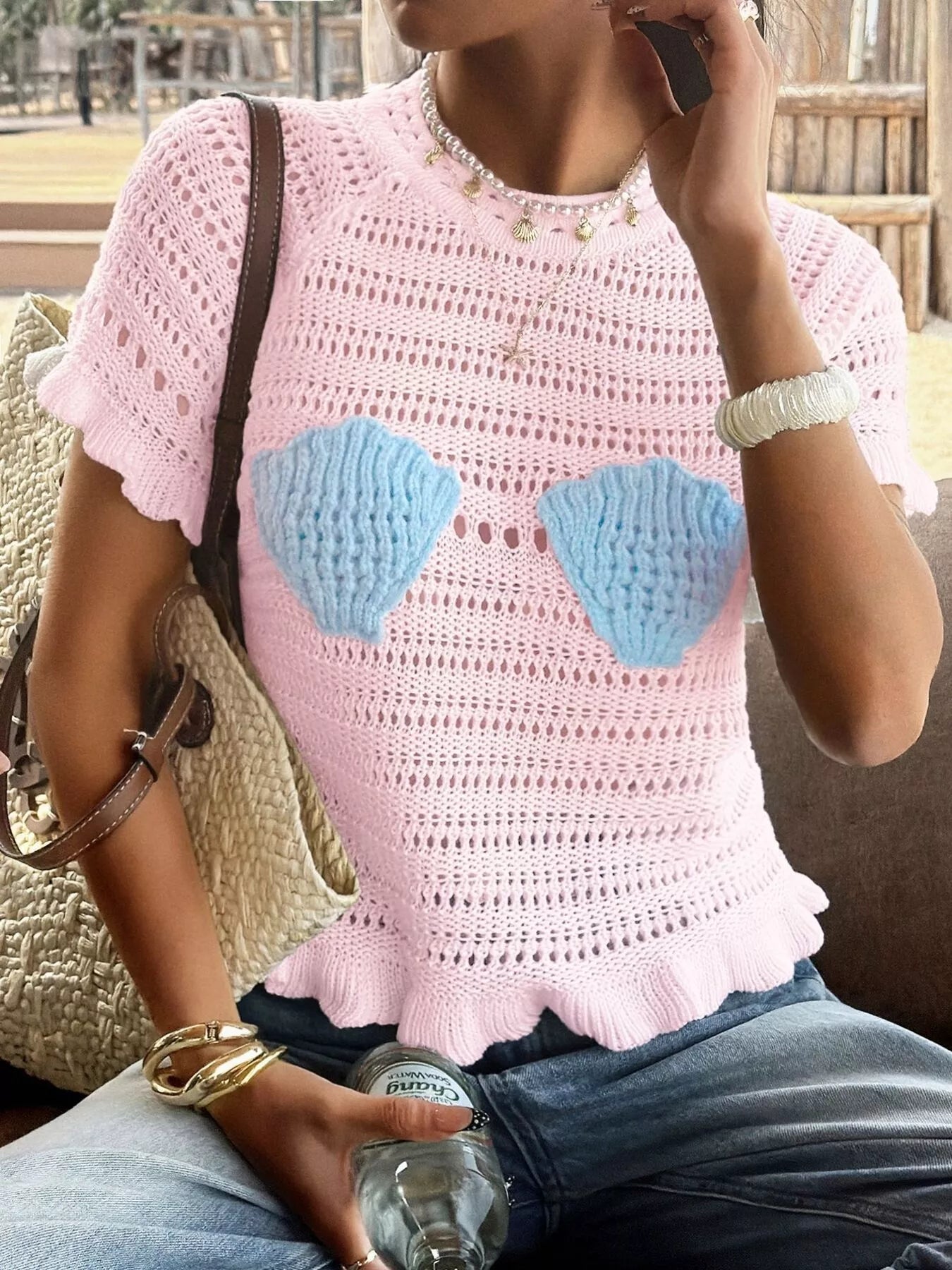 Openwork ruffled hem knit top from Trendsi featuring a stylish open-knit design and feminine ruffled hem detail.