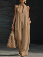 Halter neck wide-leg jumpsuit by Trendsi featuring a stylish design, with a fitted bodice and flowing wide-leg pants.