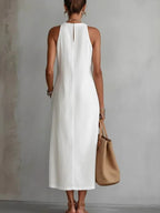 Sleeveless hollow-out midi dress with side slit and pockets from Trendsi, showing the stylish design and lightweight fabric.