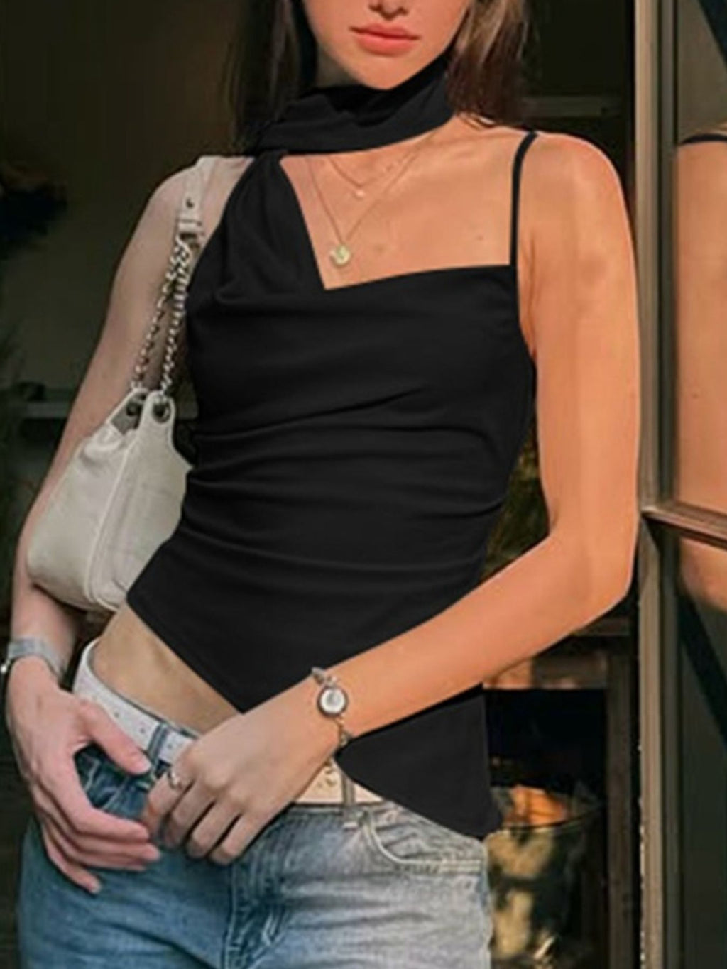 Women's asymmetrical ruched cami top with tie detail, trendy sleeveless blouse from Trendsi, shown in black fabric with ruching design.
