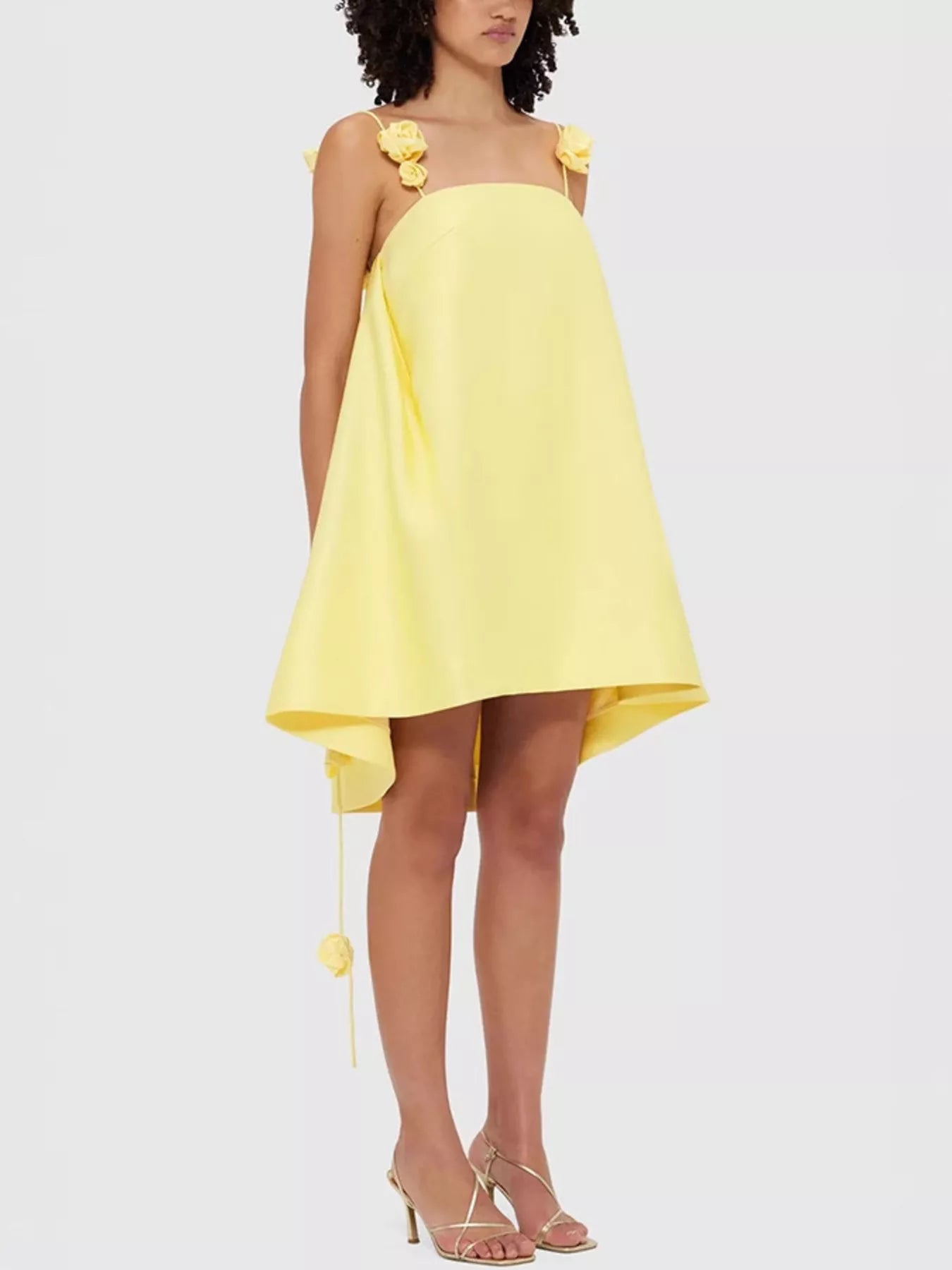 Floral strap mini A-line dress by Trendsi featuring a fitted bodice and flowy skirt with colorful flower patterns.