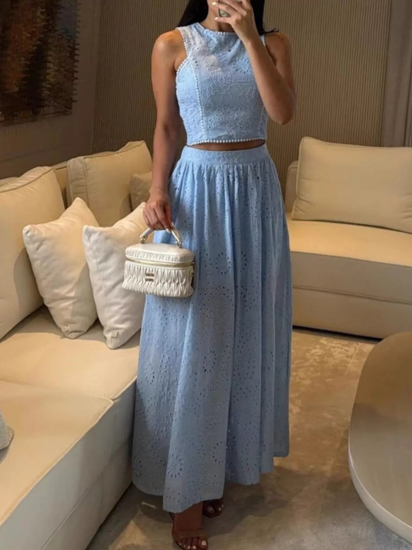 Trendsi eyelet crop top and maxi skirt set featuring a stylish coordinated look with eyelet fabric and modern design.