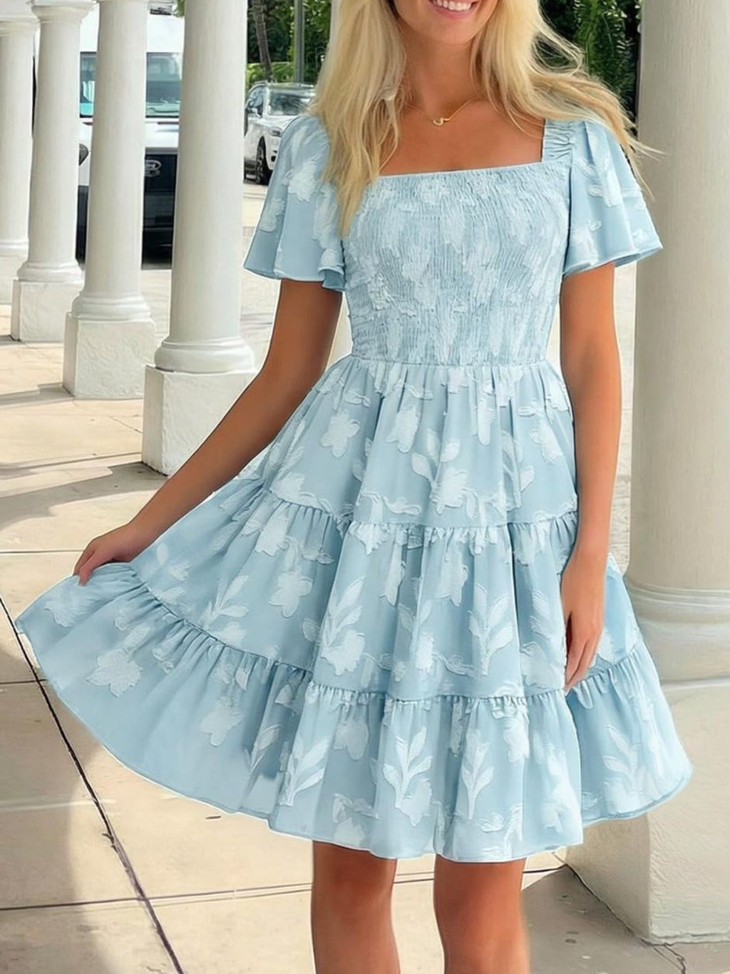 Women's smocked tiered square neck short sleeve casual dress with pockets by Trendsi, featuring a feminine silhouette and comfortable design.