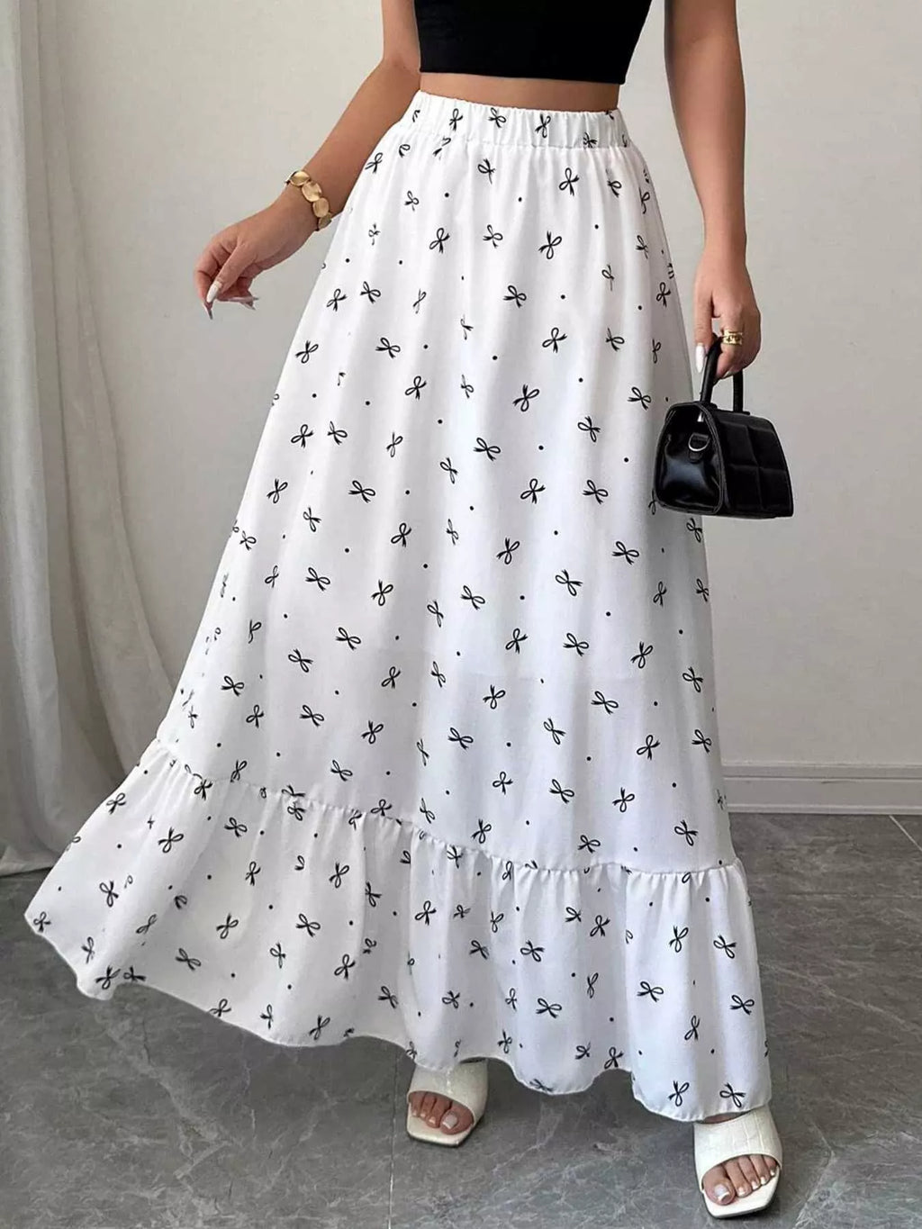 Maxi skirt with bowknot print and ruffle hem by Trendsi, featuring a flowy design and stylish pattern.