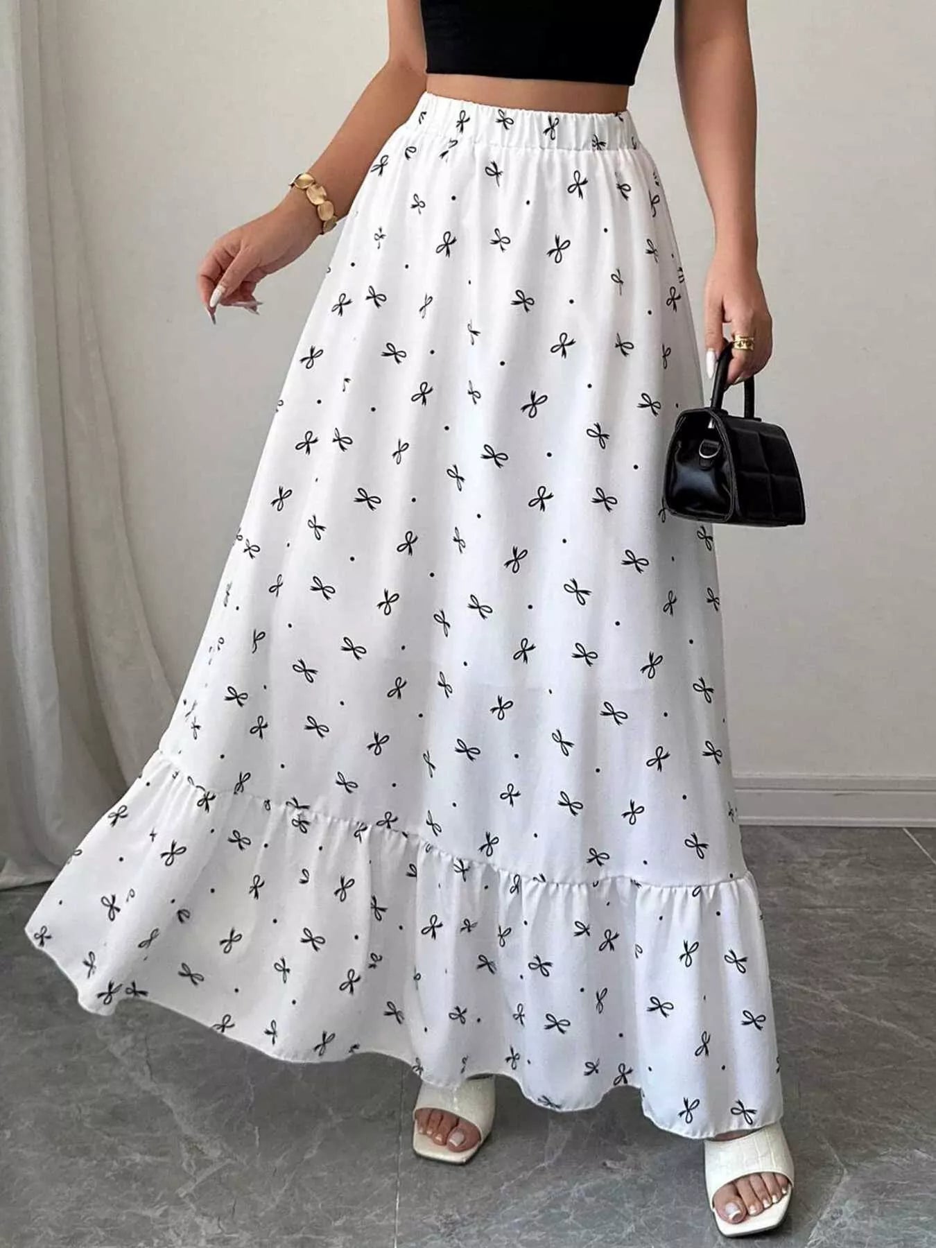 Maxi skirt with bowknot print and ruffle hem by Trendsi, featuring a flowy design and stylish pattern.