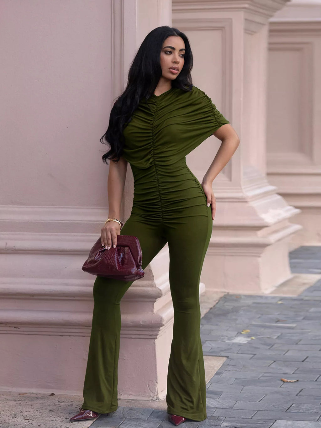 Trendsi ruched flare leg jumpsuit with fitted bodice and wide leg design, shown in black fabric on a model.