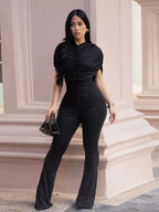 Ruched flare leg jumpsuit by Trendsi featuring a fitted bodice, ruched details, and wide flare legs in a stylish, elegant design.