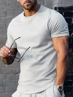 Men's plus size solid color casual T-shirt by Trendsi, showing a relaxed fit and comfortable fabric in a neutral shade.