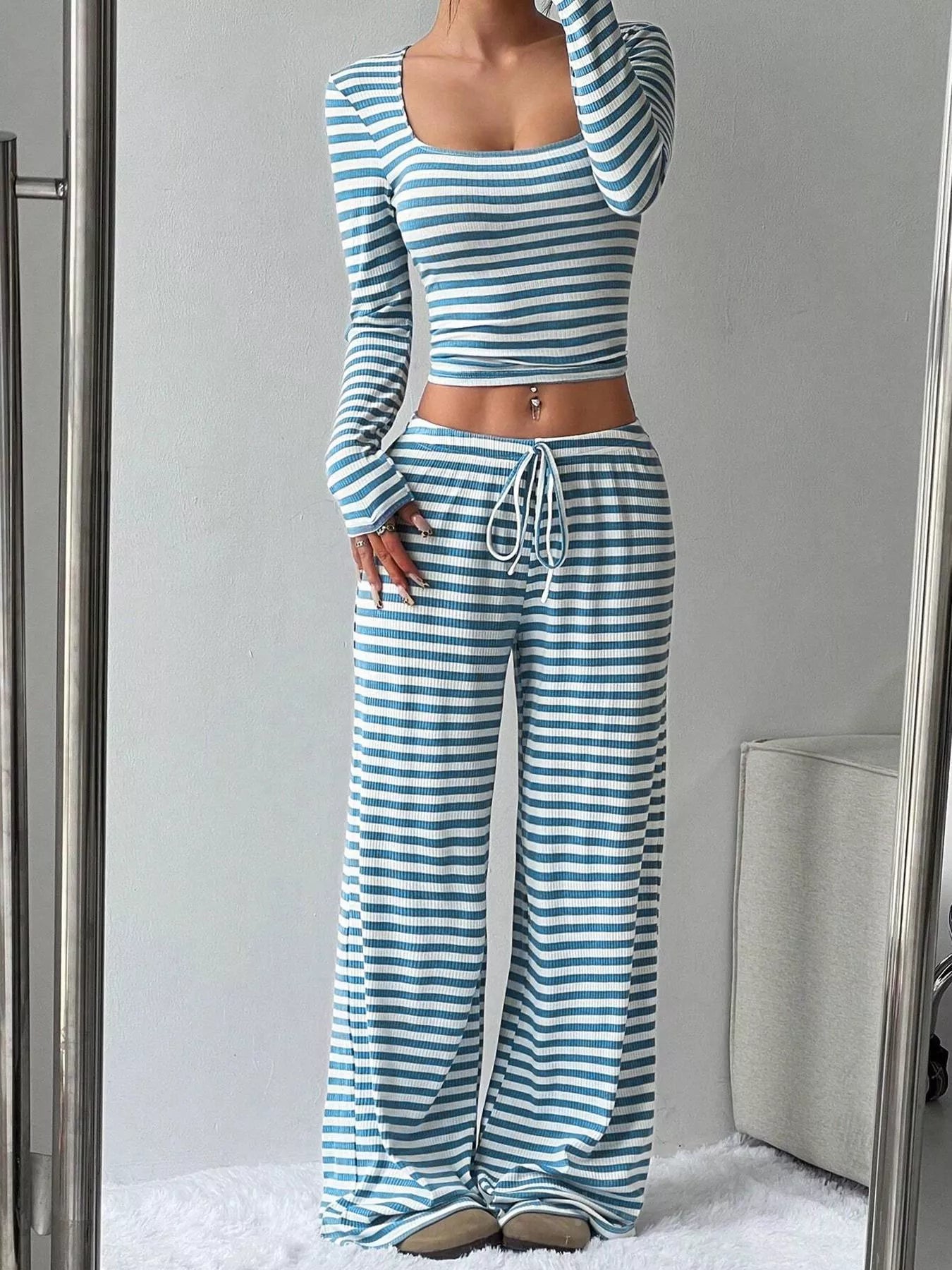 Striped long sleeve crop top and wide-leg pants set from Trendsi, featuring a stylish matching clothing ensemble.