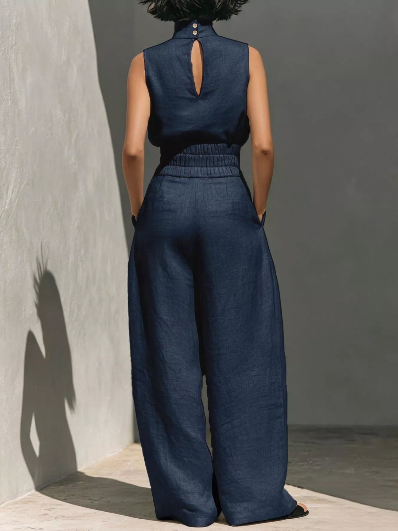 Sleeveless turtleneck top and wide-leg pants set by Trendsi, featuring a stylish, coordinated outfit with a modern silhouette.