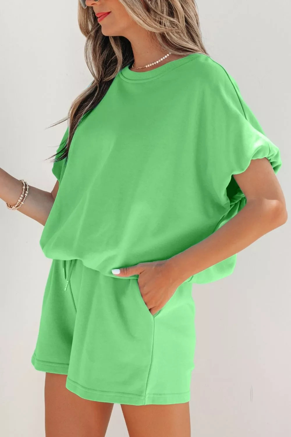 Solid color puffy loose top and drawstring shorts 2-piece outfit by Trendsi, featuring a comfortable, casual summer look.