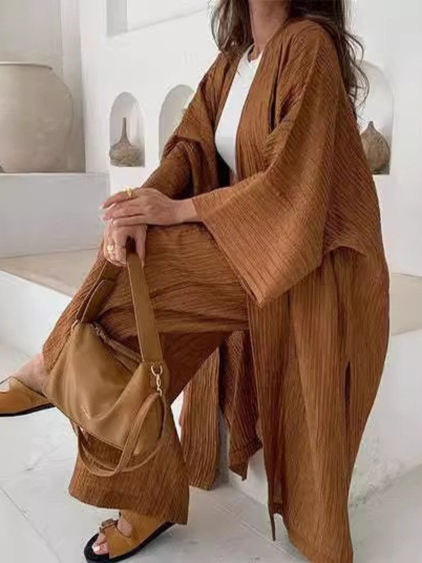 Women's textured knit cardigan and matching pants loungewear set by Trendsi, featuring cozy, stylish knit fabric and relaxed fit.