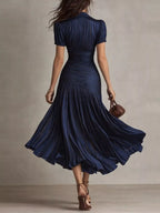 Pleated striped short sleeve midi dress by Trendsi featuring a flowy silhouette and classic pattern, perfect for casual and semi-formal wear.