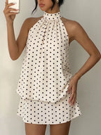 Polka dot halter neck mini dress by Trendsi featuring a fitted silhouette and stylish halter straps.
