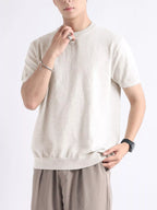 Men's plus size casual knitted short sleeve T-shirt by Trendsi, featuring a comfortable fit and soft fabric in a simple design.