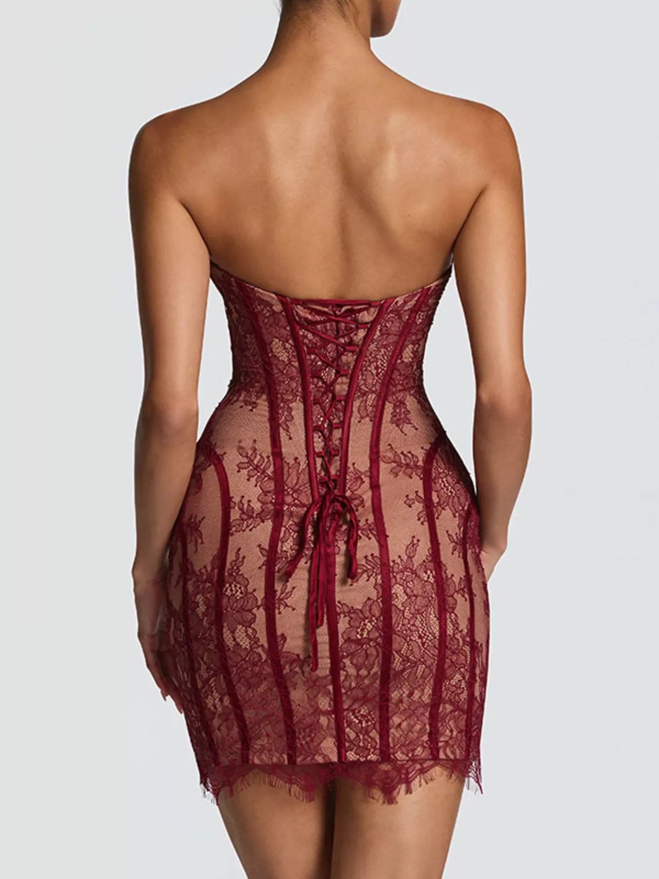 Lace detail tube mini dress by Trendsi featuring fitted design, sleeveless style, and intricate lace accents.