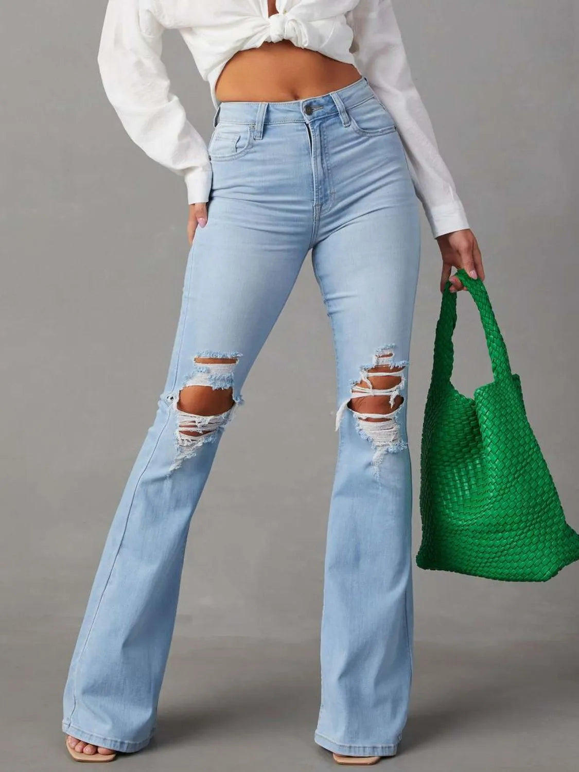 Distressed jeans with front and back pockets from Trendsi, featuring a casual, worn-in denim look and stylish details.