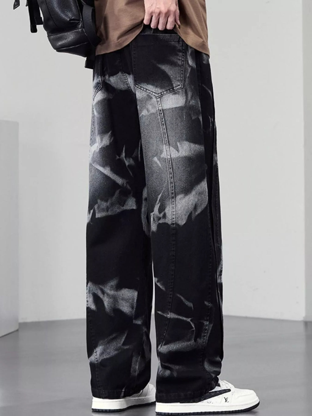 Men's plus size washed wide-leg jeans by Trendsi featuring relaxed fit and faded denim, displayed on a hanger.