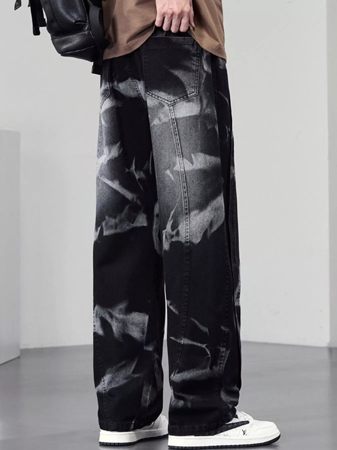 Men's plus size washed wide-leg jeans by Trendsi featuring relaxed fit and faded denim, displayed on a hanger.