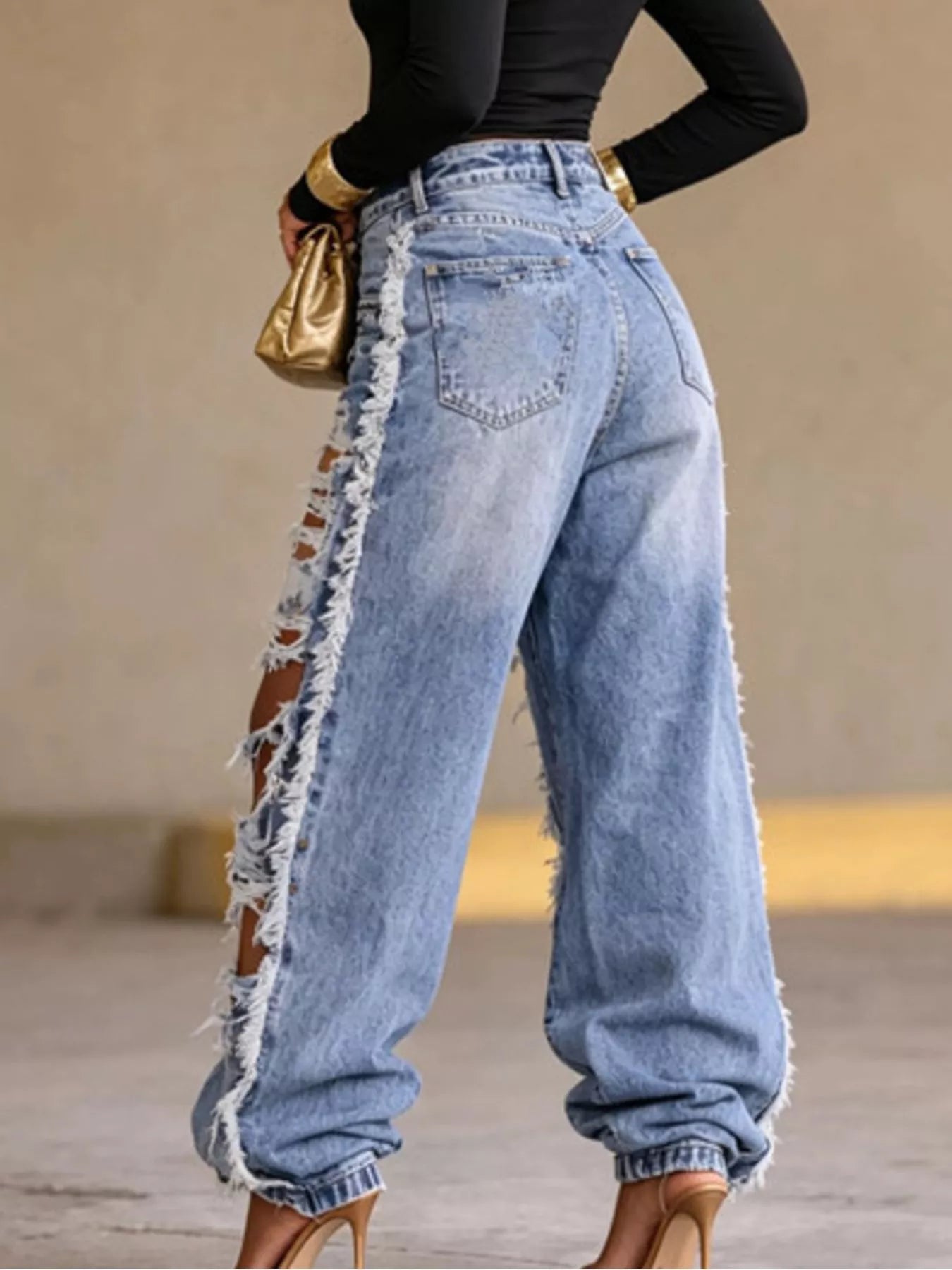 Distressed loose fit denim jeans from Plush Fashion Hub showing faded, ripped details and relaxed style on a white background.