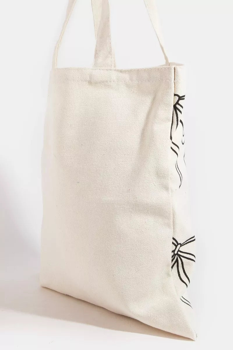 Lightweight polyester tote bag with feminine ribbon bow tie print, designed by Trendsi, featuring shoulder strap and spacious interior.