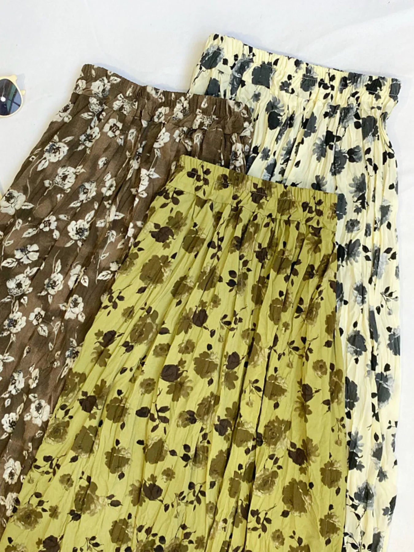 Floral print elastic waist midi skirt from Trendsi, flowing fabric with vibrant flower patterns and a comfortable fit.