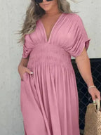 Plus size maxi dress by Trendsi featuring a slit V-neck, smocked waist, and full-length design perfect for elegant summer wear.