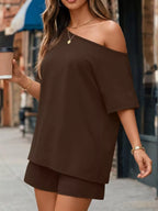 Plus size full set featuring a one-shoulder top and matching shorts by Trendsi, shown in a stylish, casual outfit.