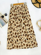 Floral print elastic waist midi skirt from Trendsi, featuring flowy fabric and a stylish, feminine design.