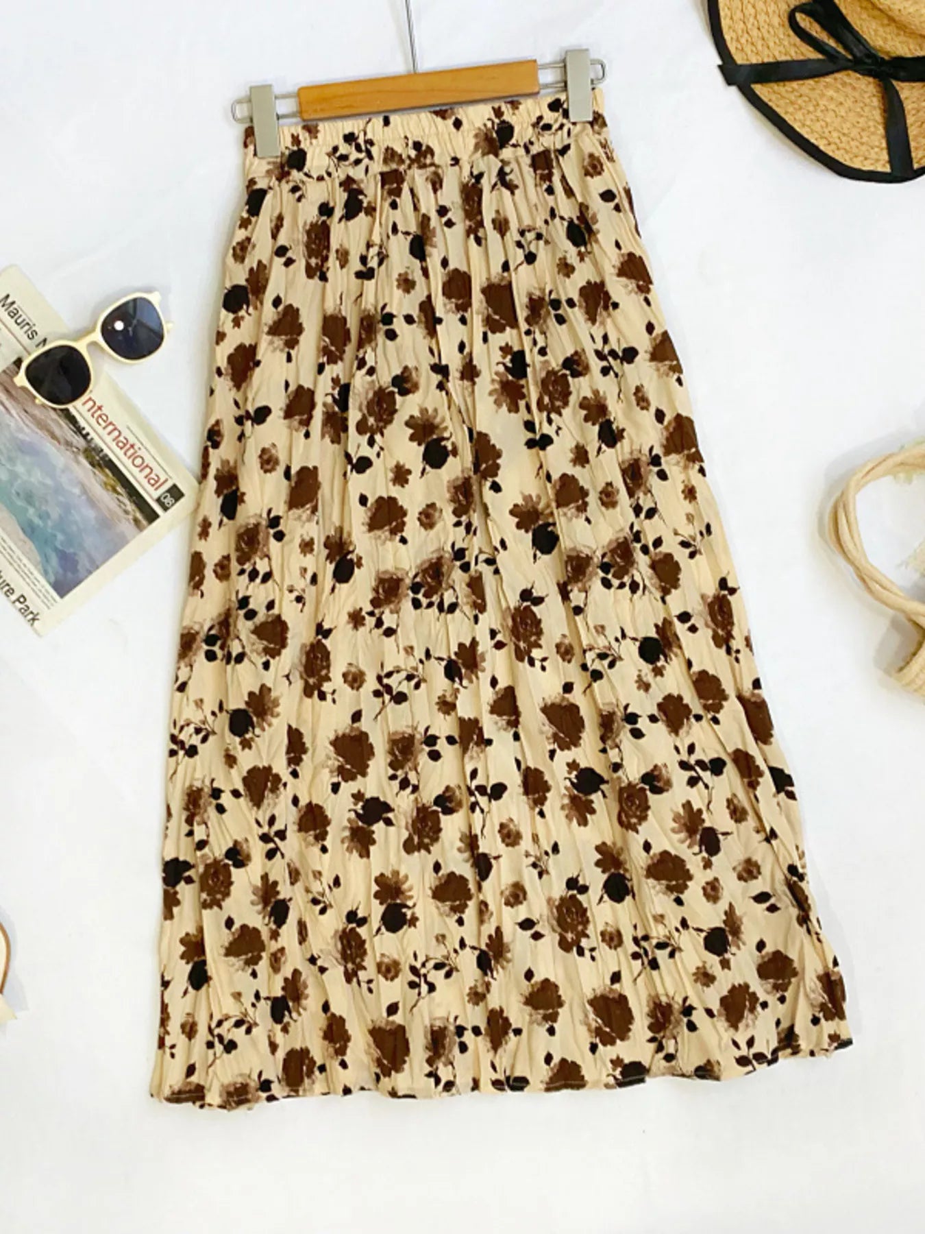 Floral print elastic waist midi skirt from Trendsi, featuring flowy fabric and a stylish, feminine design.