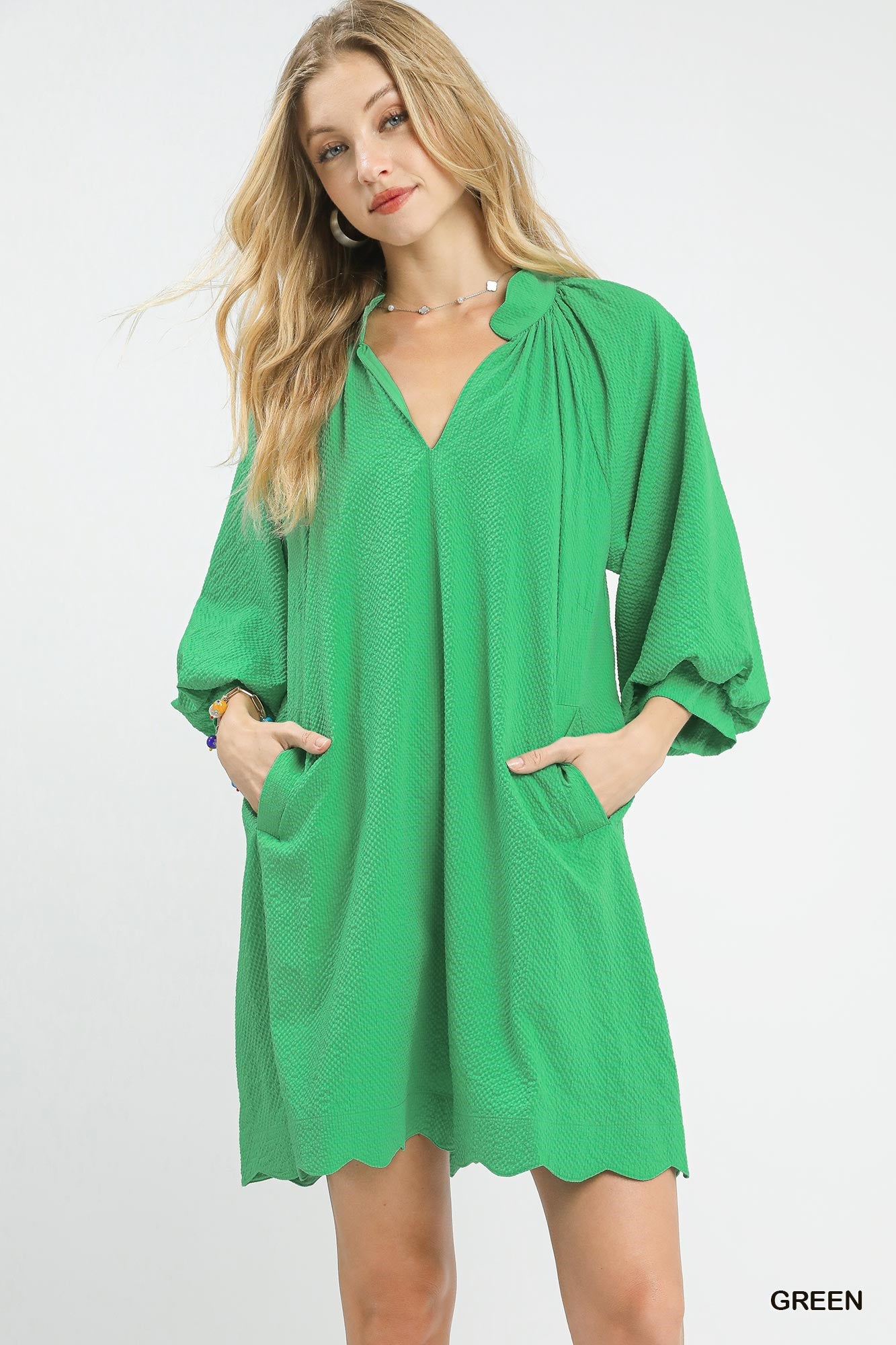 Vibrant green textured V-neck mini dress with balloon sleeves by Plush Fashion Hub, showcasing its stylish design and fabric detail.