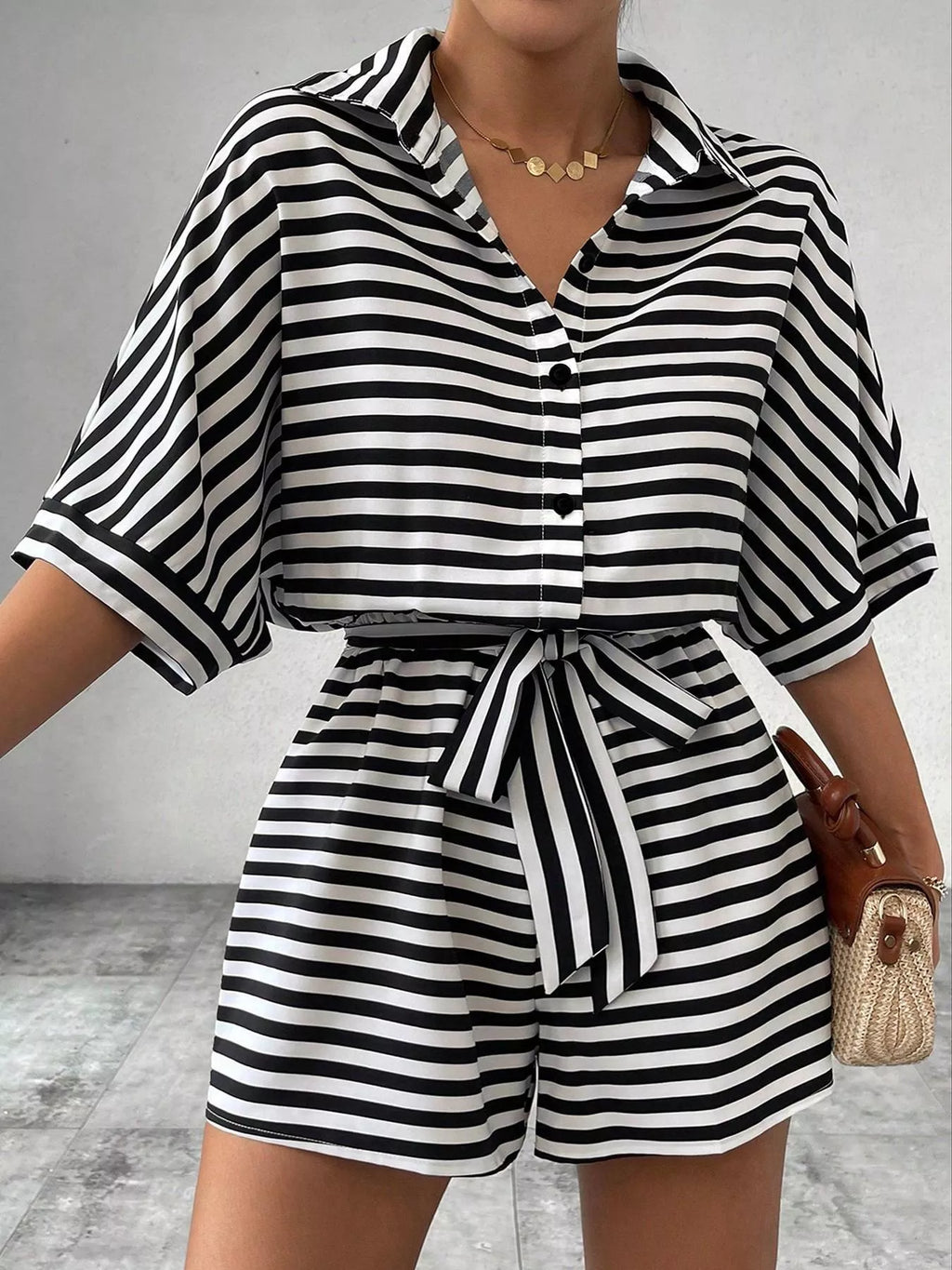 Striped button-up belted romper by Trendsi featuring a casual fit with a waist belt and short sleeves.