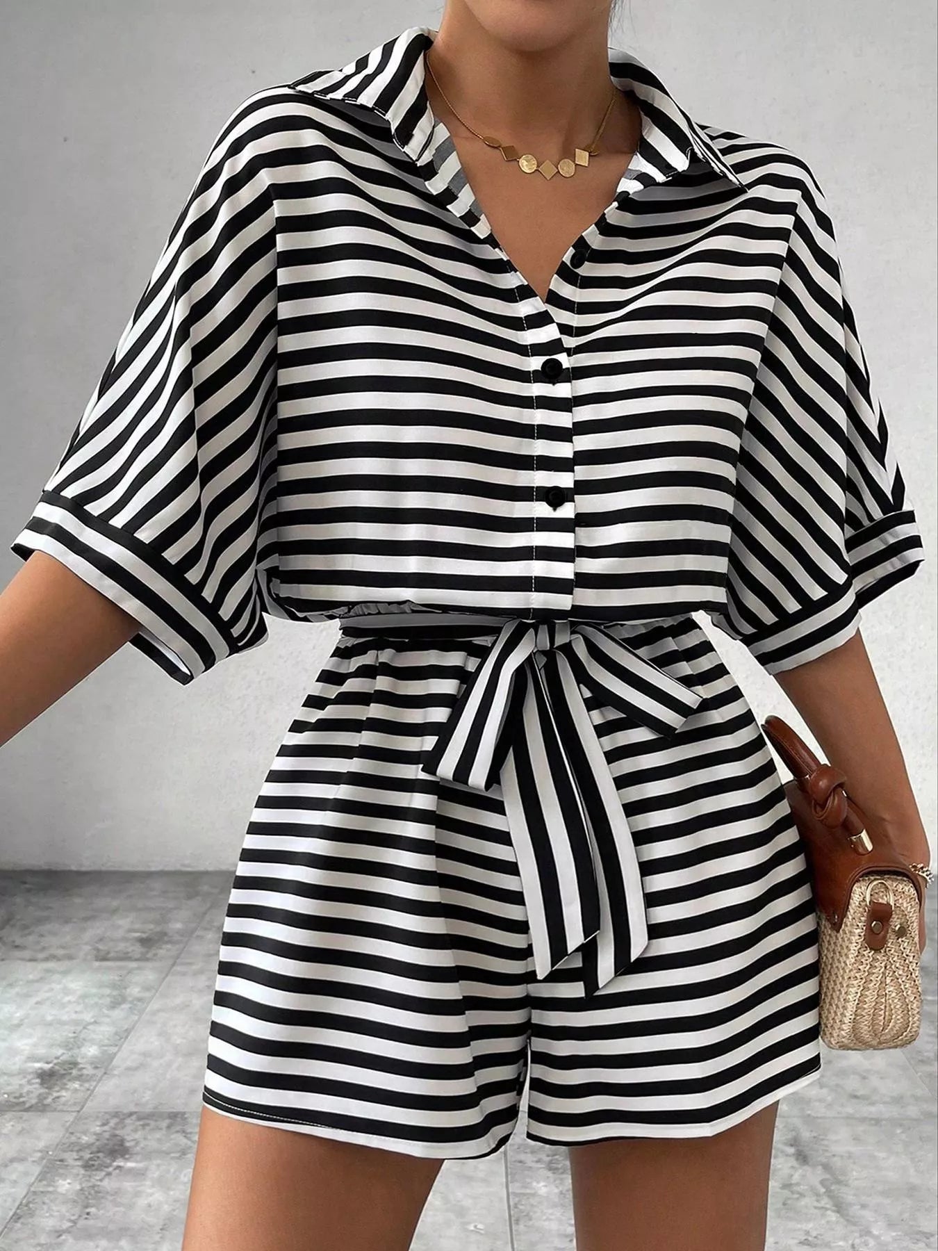 Striped button-up belted romper by Trendsi featuring a casual fit with a waist belt and short sleeves.